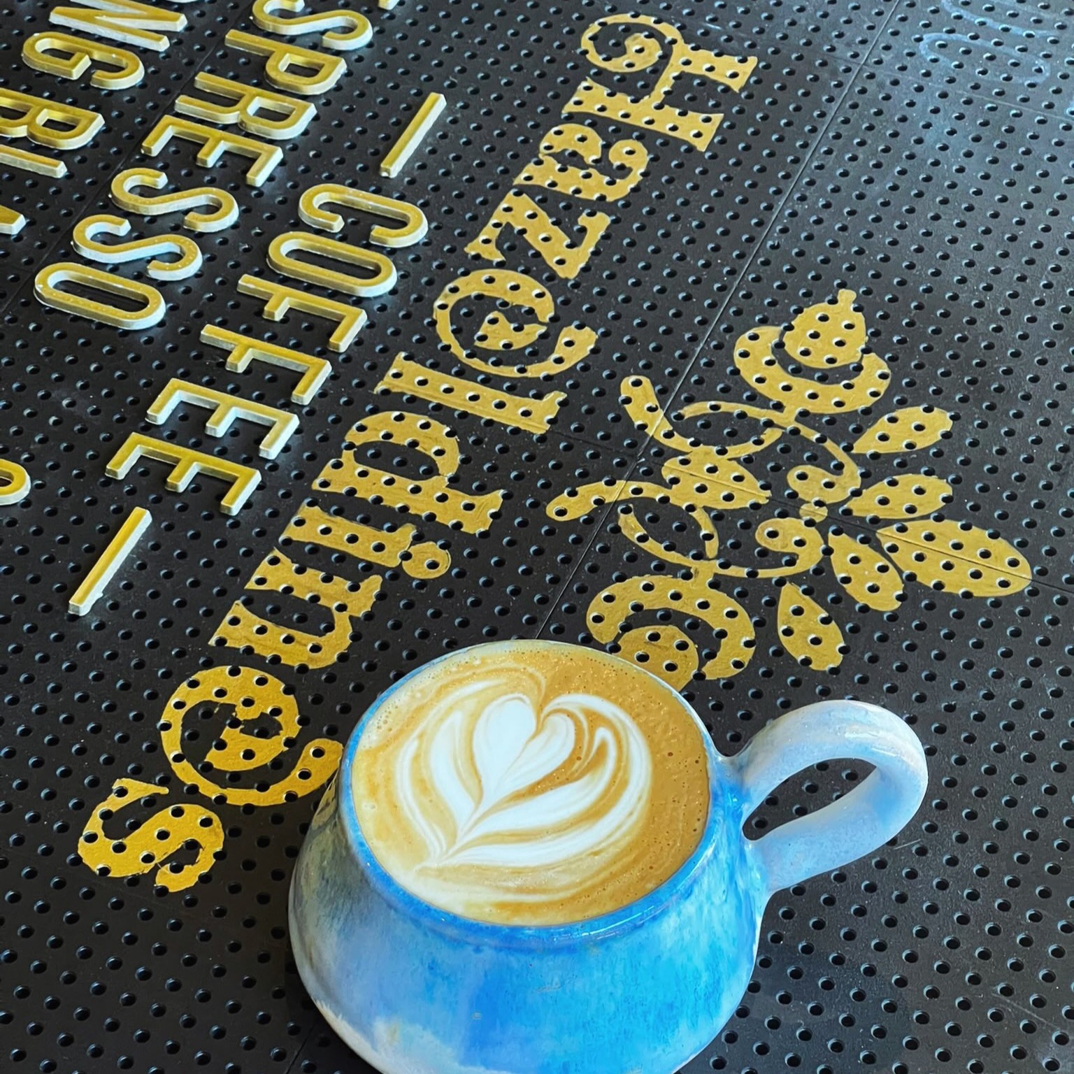 Latte art in a handmade cup on the Hazeldines counter